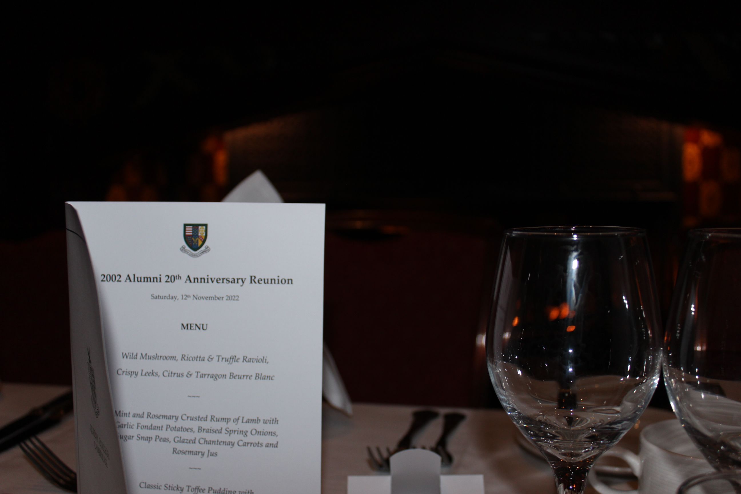 Menu on a table with a wine glass in the foreground