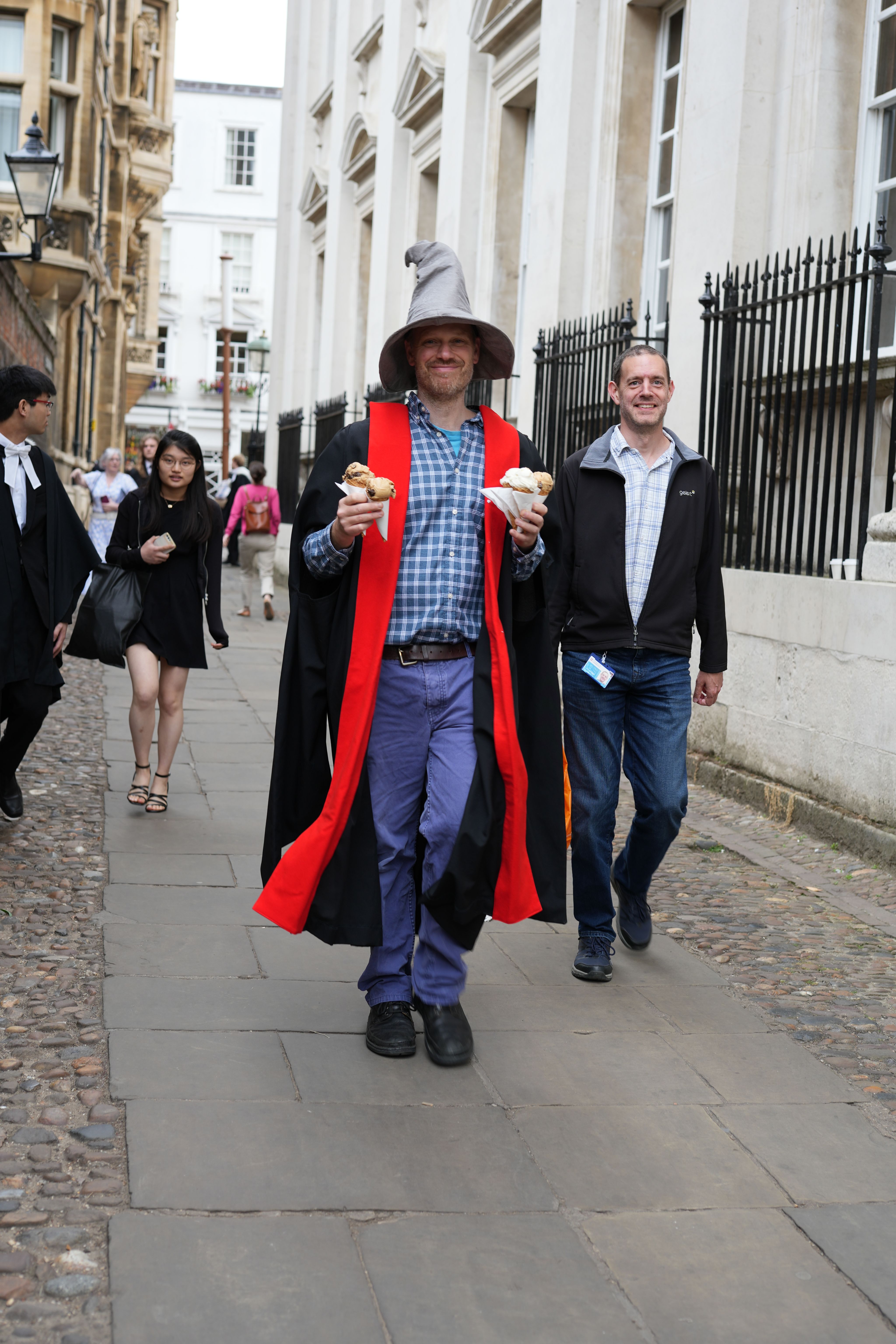 Man in wizard hat holding four ice creams