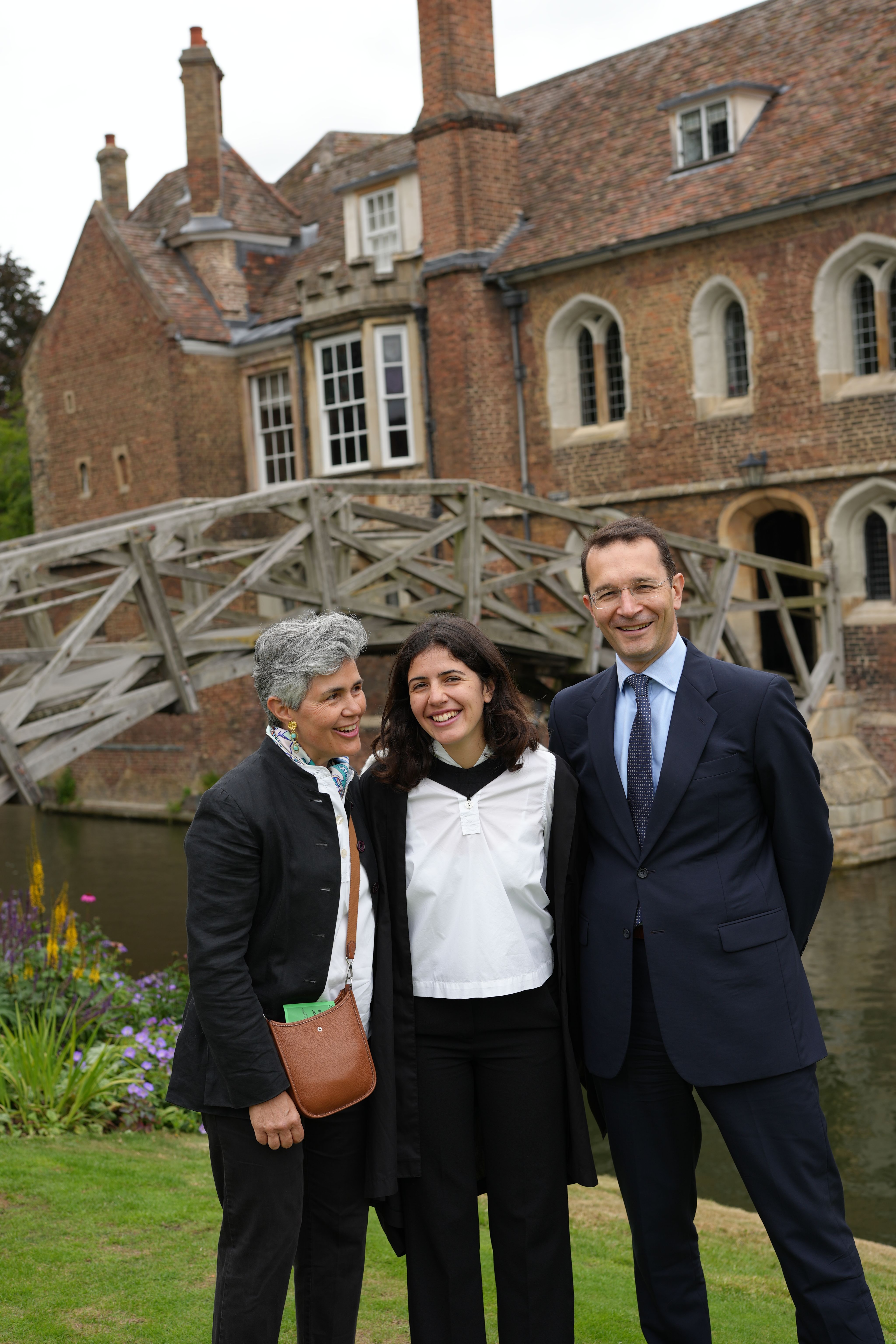 3 people posing in front of the bridge