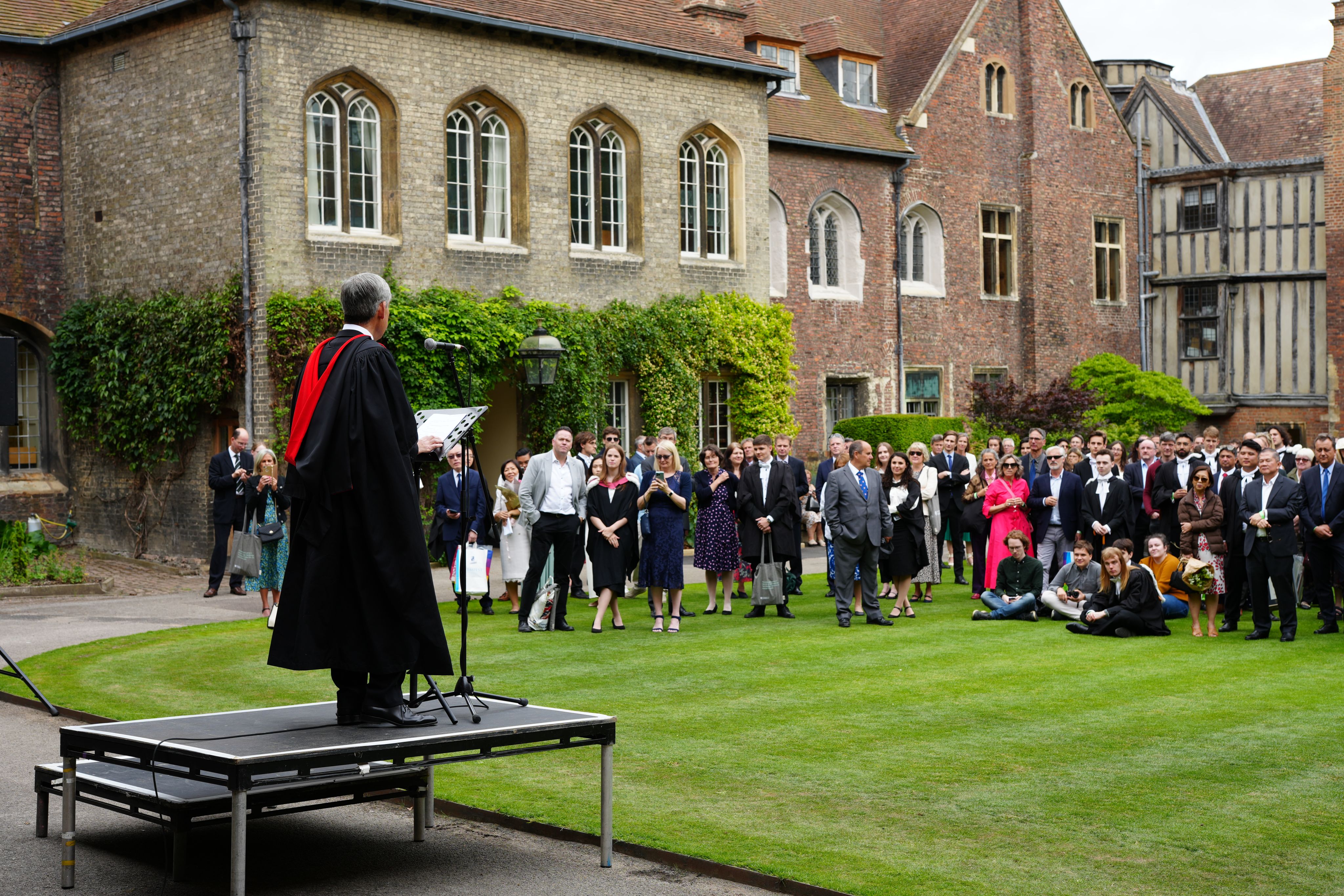 Queens' President giving a speech