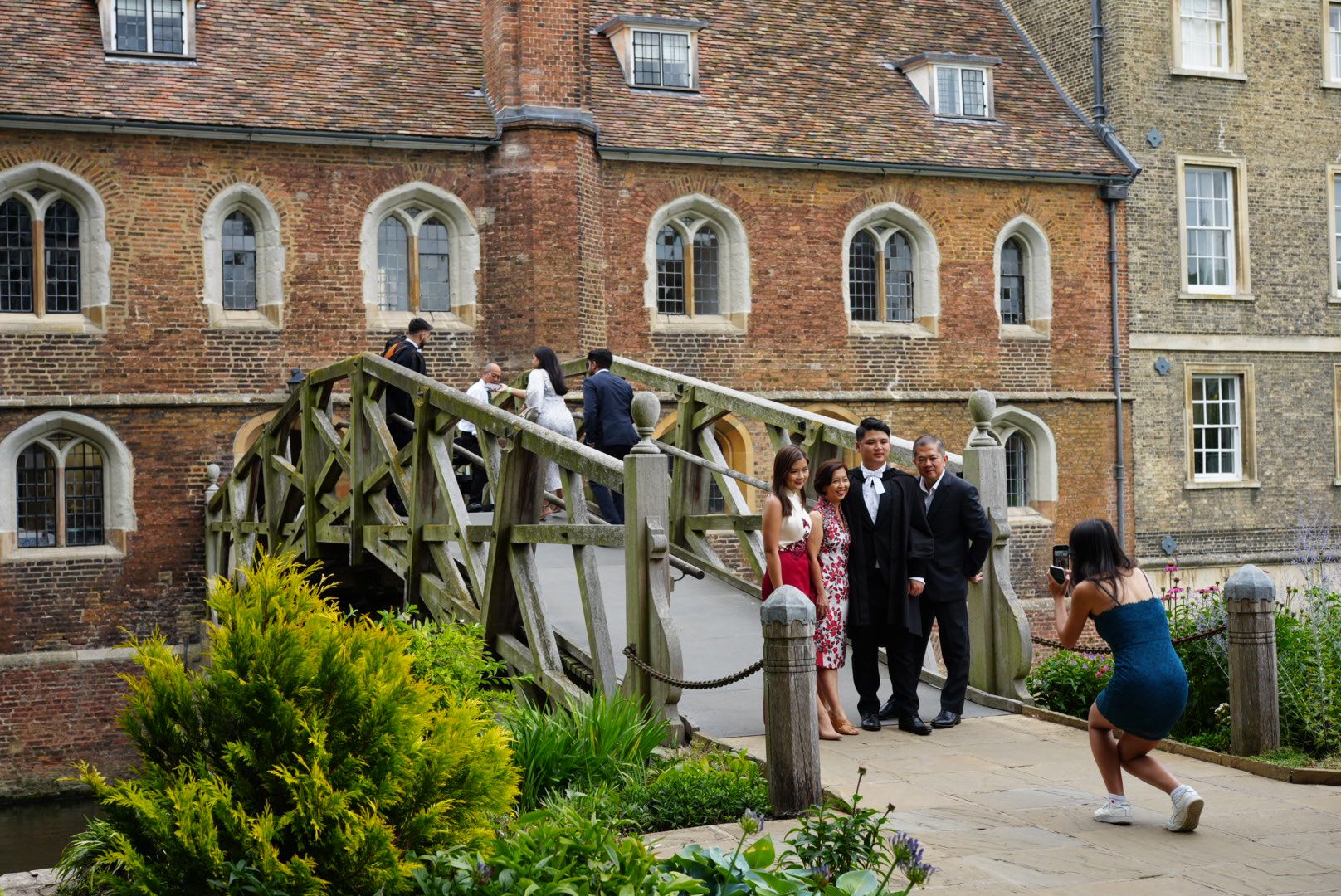 Students posing for photos with bridge