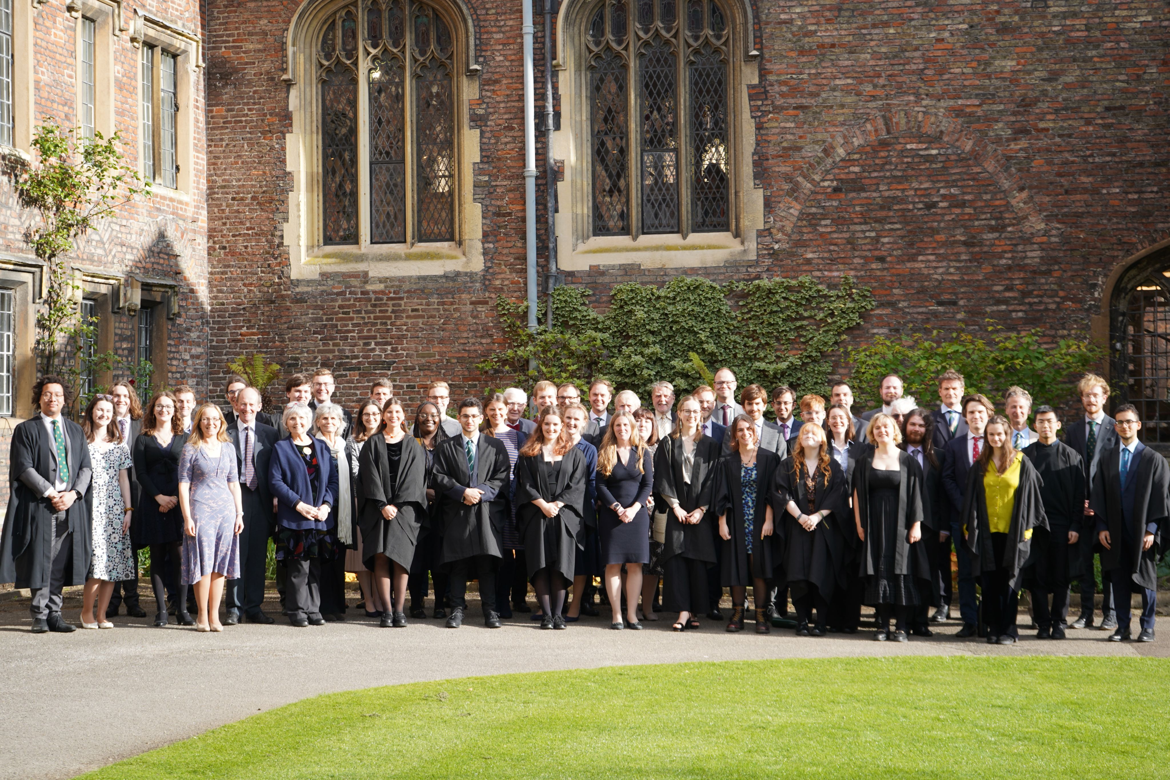 A group photograph of alumni in Walnut Tree Court