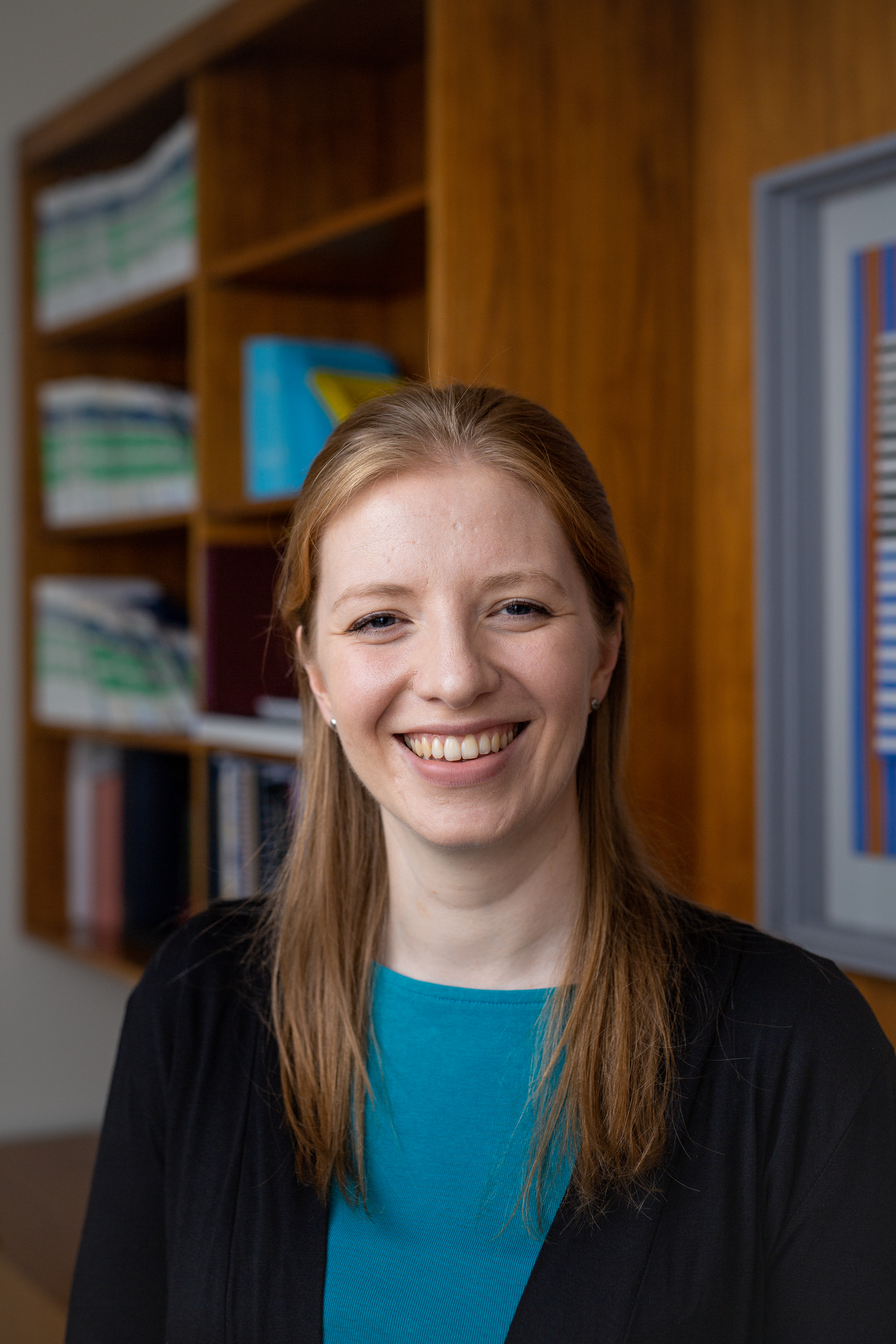 A woman with strawberry blonde hair smiling for the camera