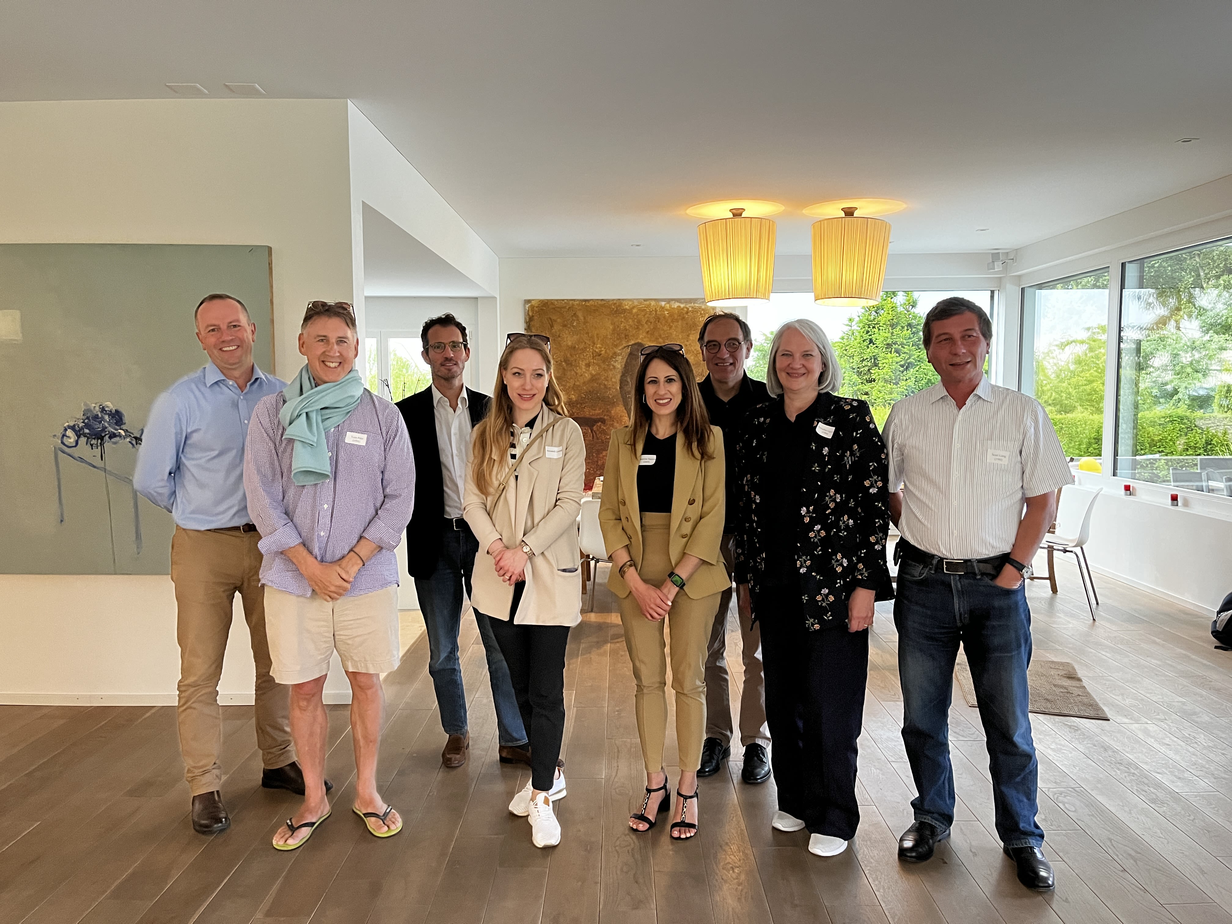 A large group of people smiling for the camera in an apartment
