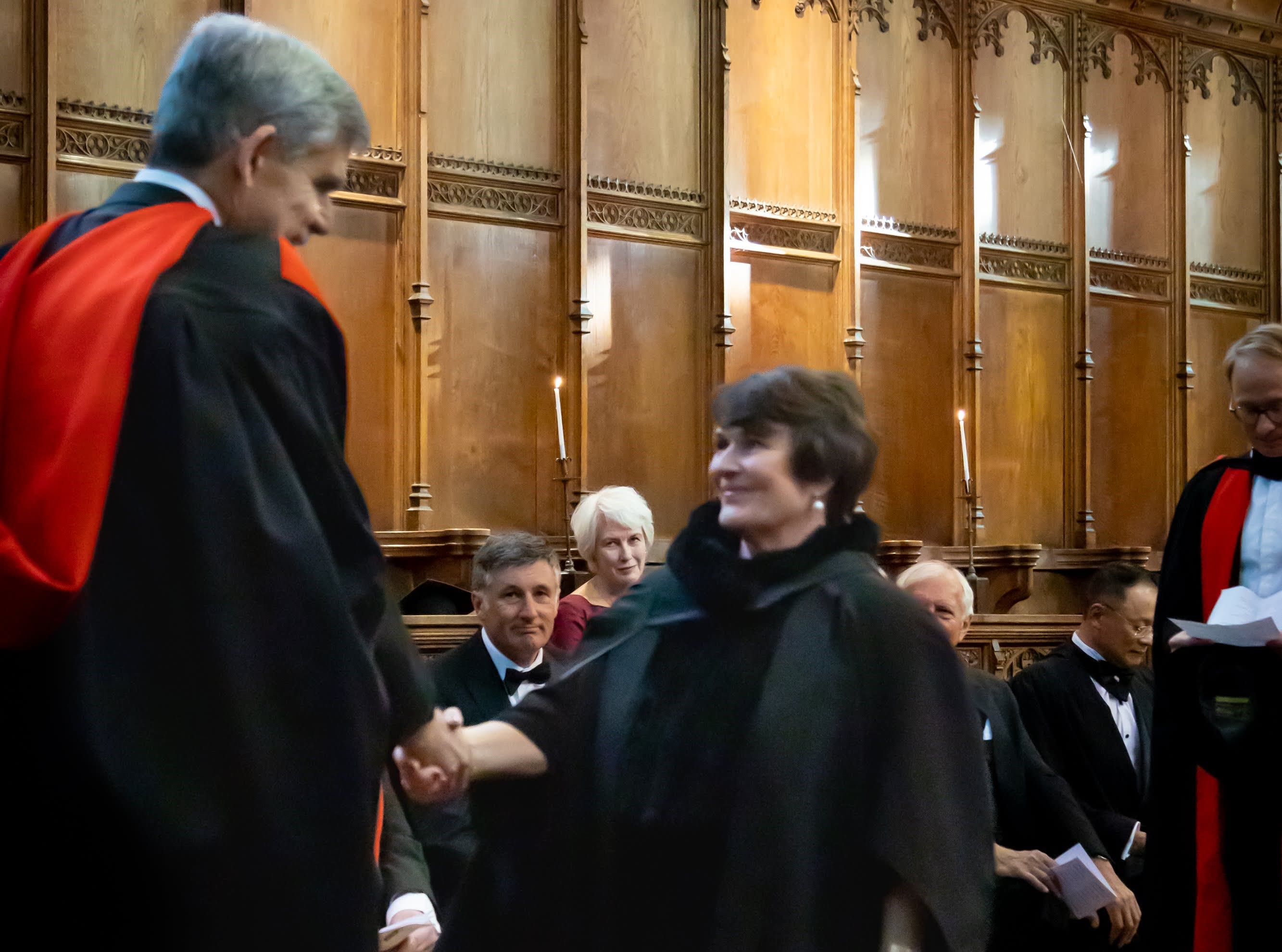 Photo of man shaking woman's hand in Chapel