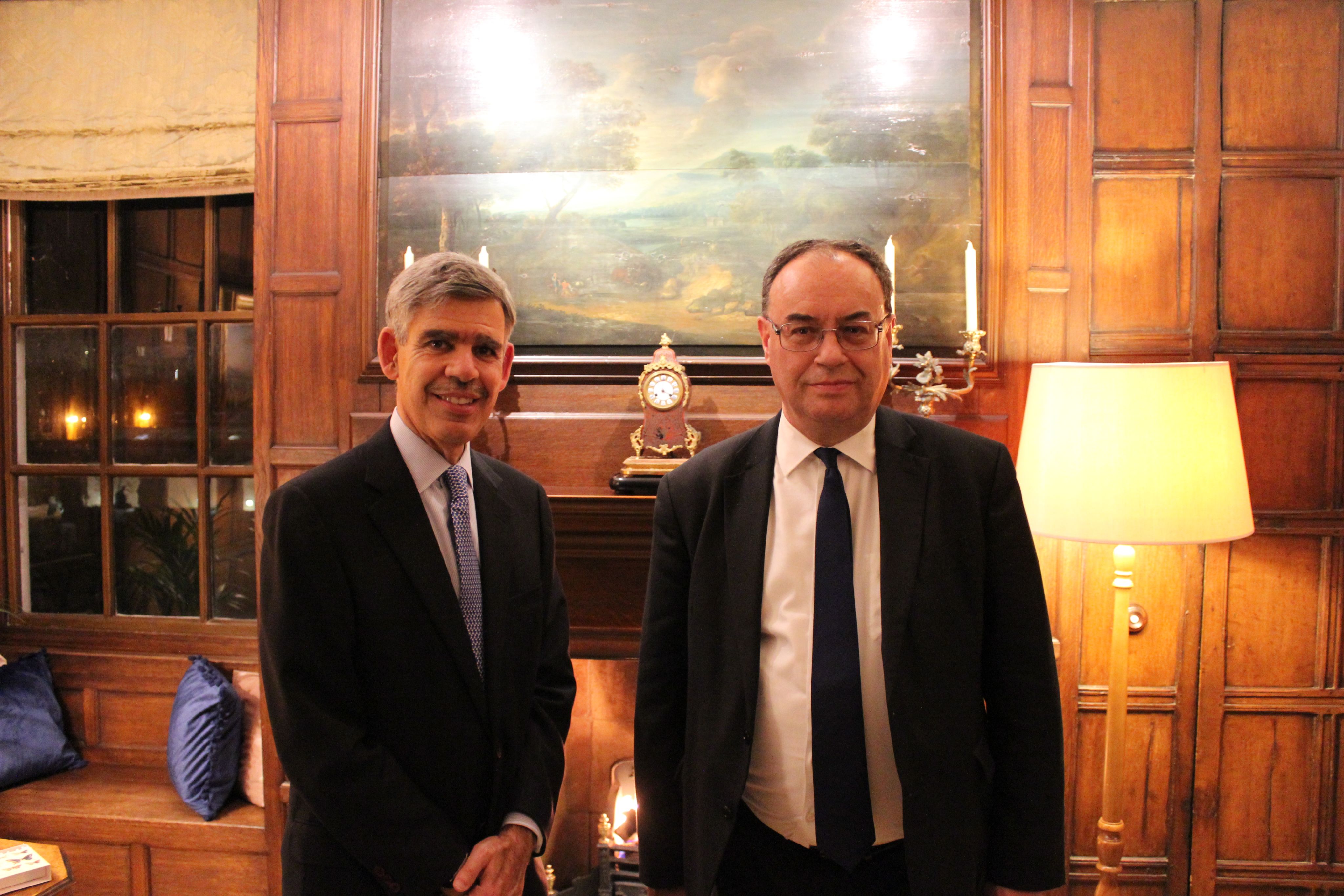 Two men standing in suits